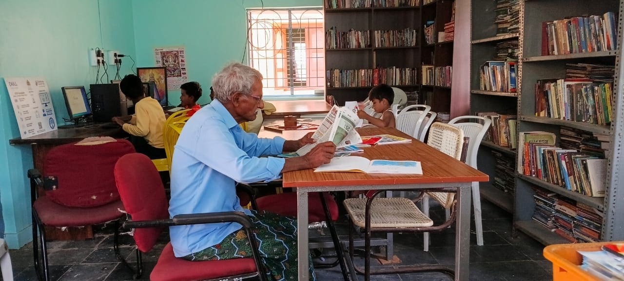 A rural library reading room, readers at a shared table